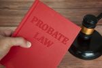 Hand holding Probate Law book with gavel background. Law concept