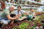 Multigenerational Caucasian family working together at the flower nursery